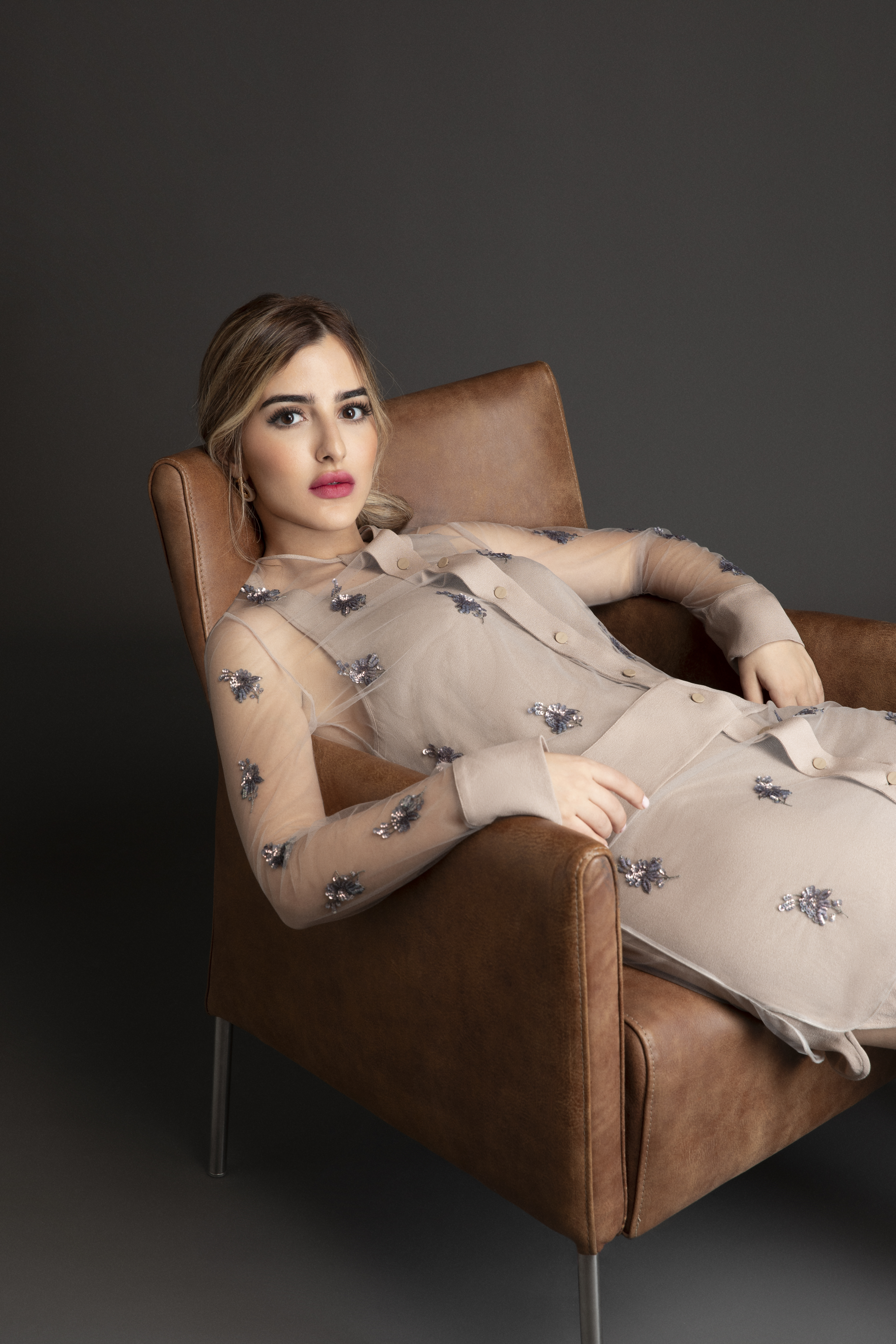 Aya Abaakil reclining in a fashion editorial portrait