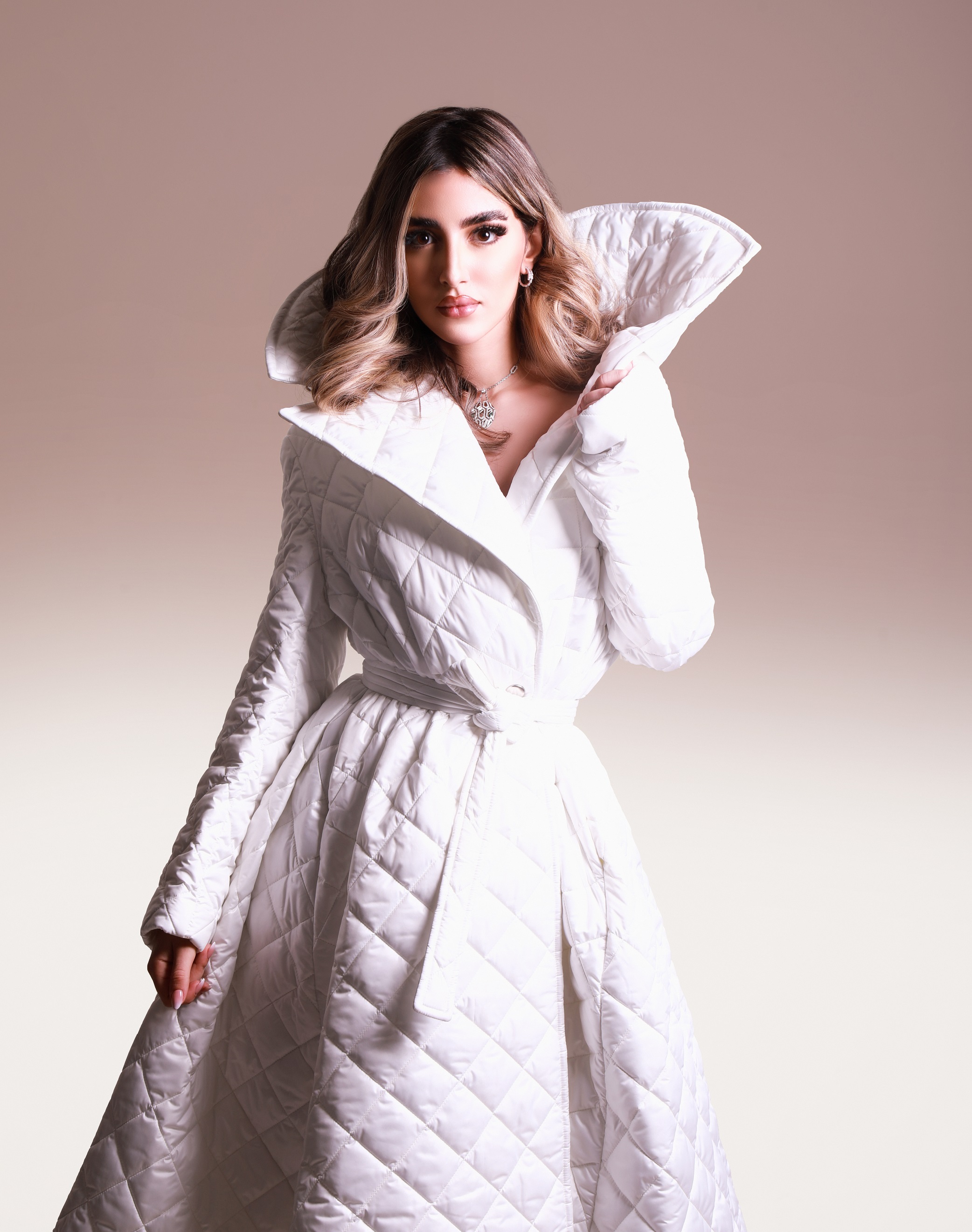 Aya Abaakil in an ivory quilted coat