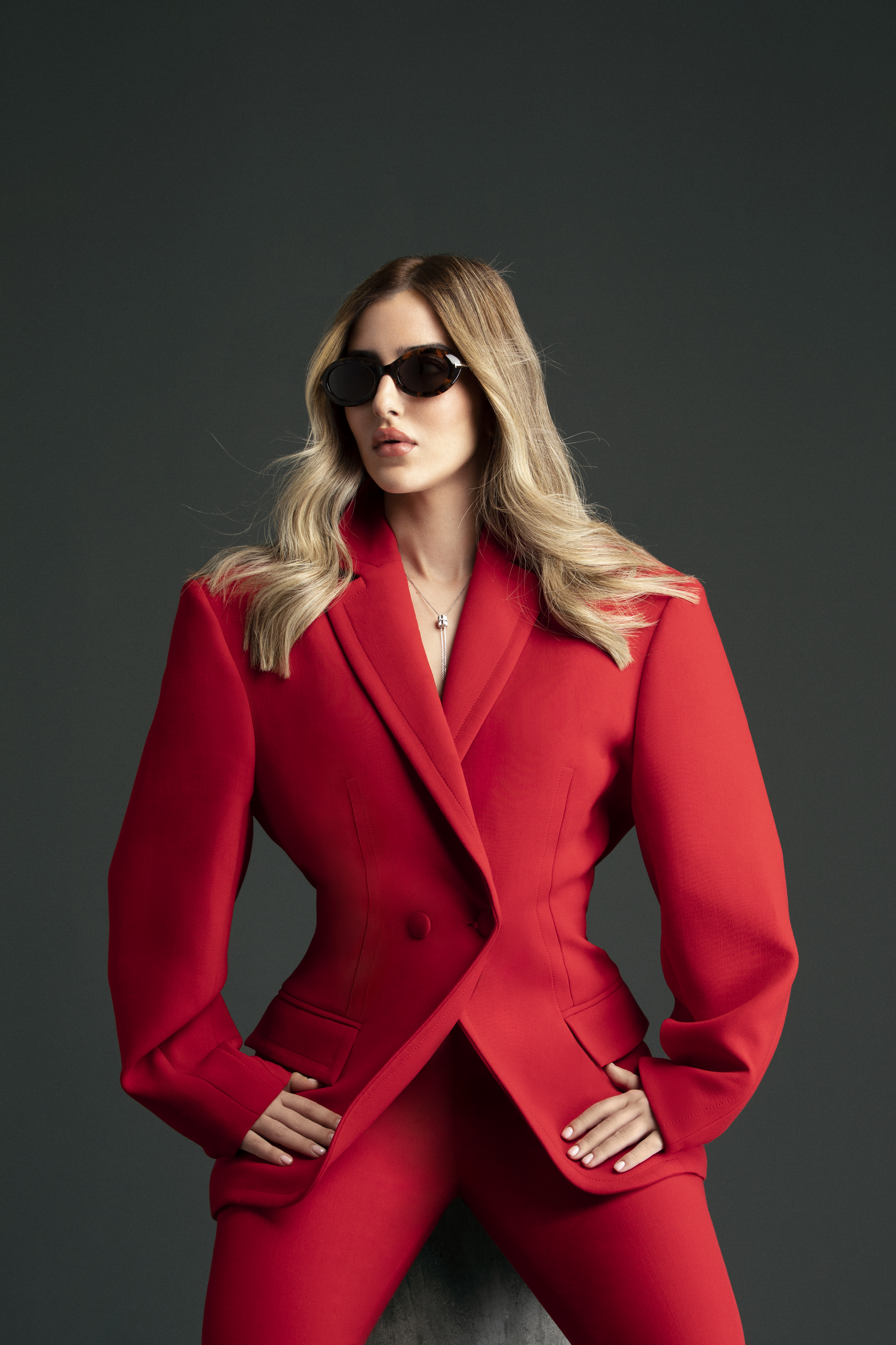 Aya Abaakil in a red tailored suit